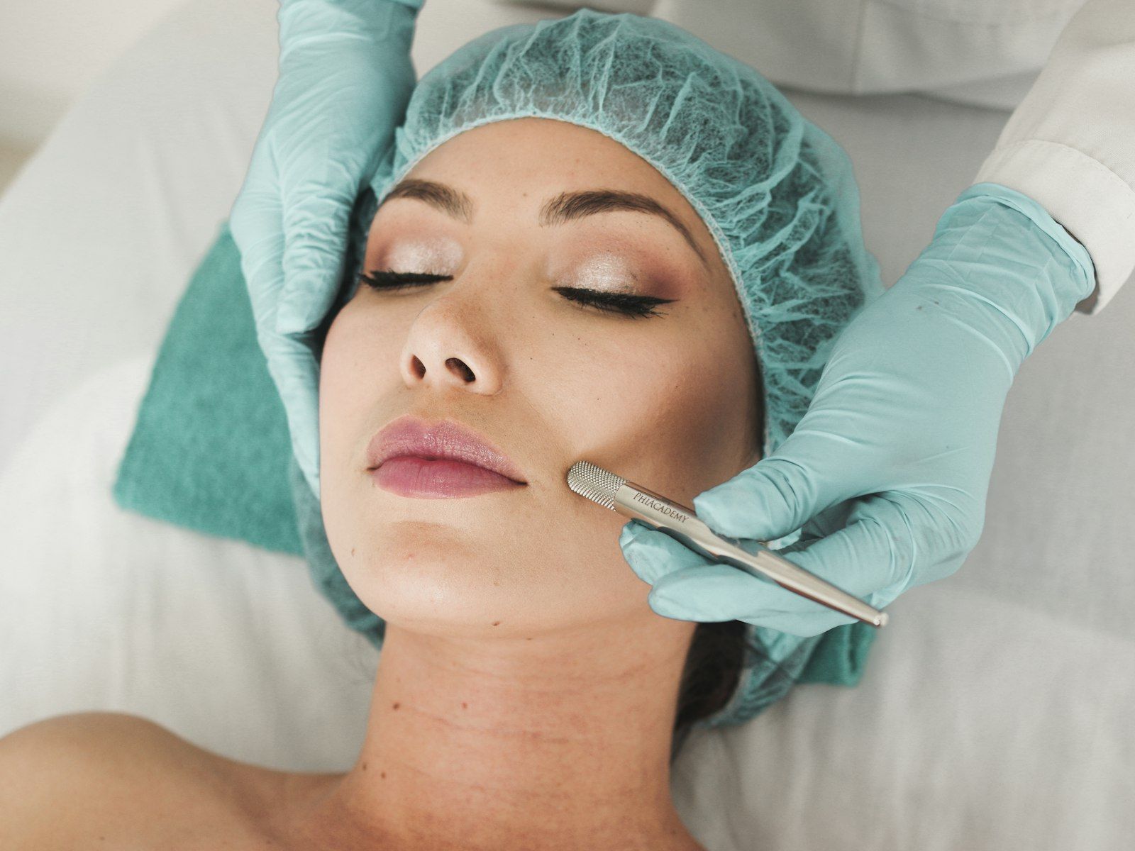 A beauty therapist gives a client a facial treatment.